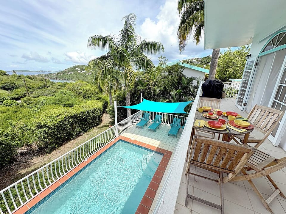Looking out towards your view of Great Cruz Bay Harbor and your private pool from the upper level