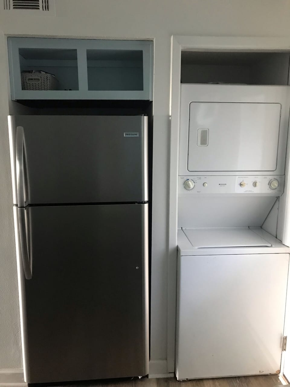 Kitchen area with new refrigerator and a washer/dryer in unit 