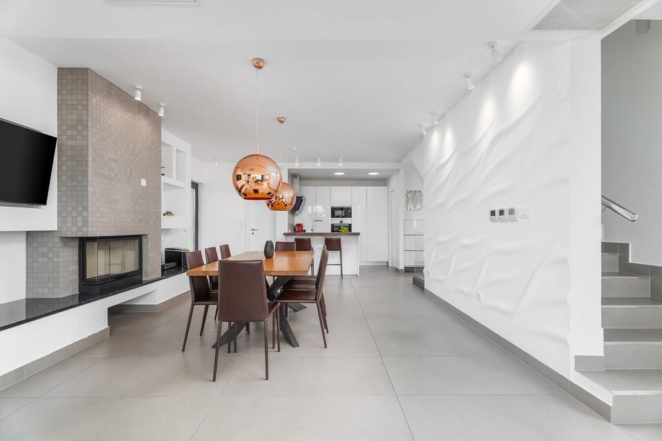 Fully equipped kitchen with exit to outdoor dining area and playground

