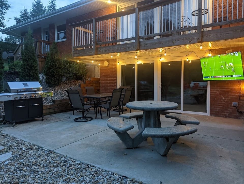 Outdoor patio with plenty of seating and and outdoor HDTV