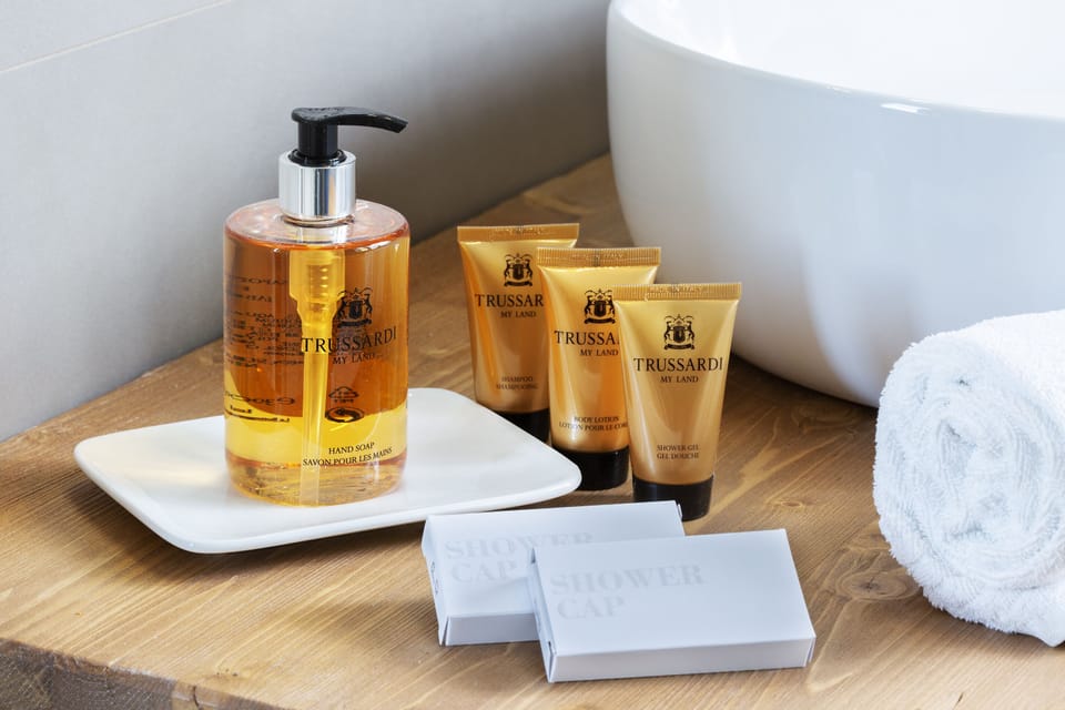 Shower, designer toiletries, hair dryer, bathrobes