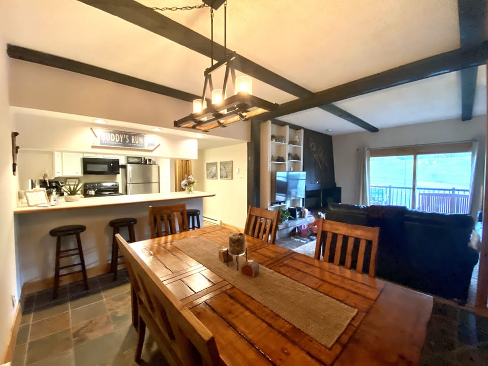 Dining area looking into kitchen and living space
