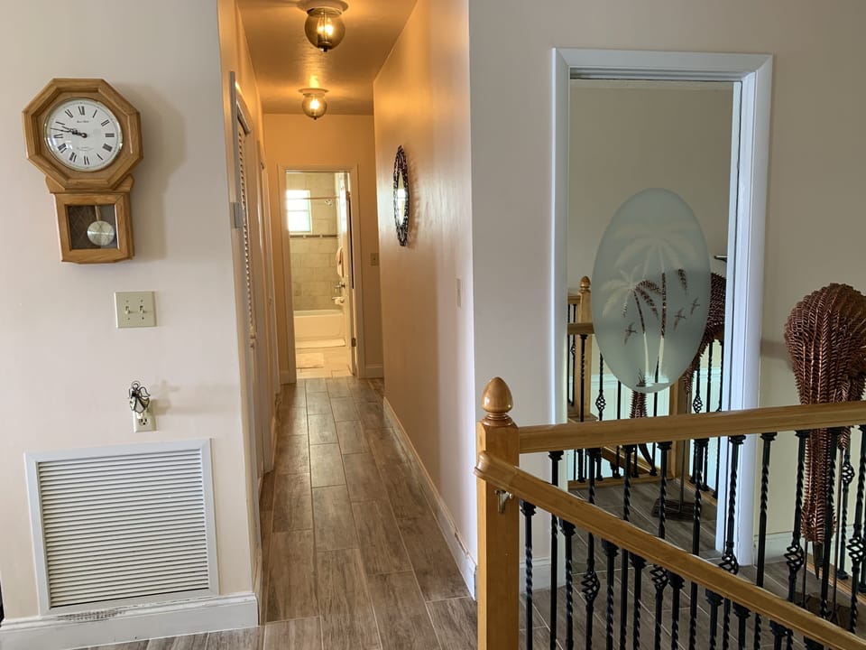 Hall way up stairs leading the 2 guest rooms and guest bathroom.
