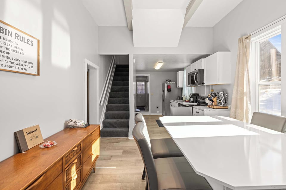 【Main Floor】 The staircase leads to all upstairs bedrooms — kitchen is straight ahead.