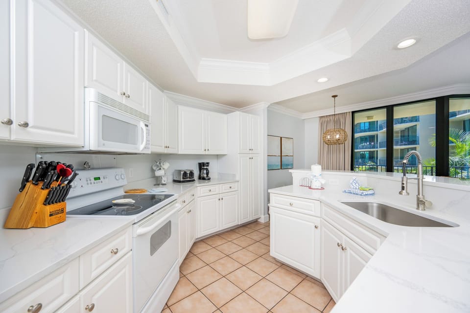 Craft delicious meals while enjoying the coastal light pouring through the windows in this inviting kitchen