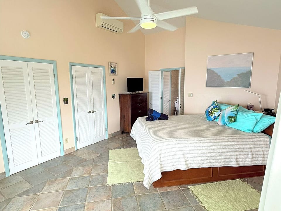 The left master bedroom includes a king bed, a/c, and ensuite bathroom