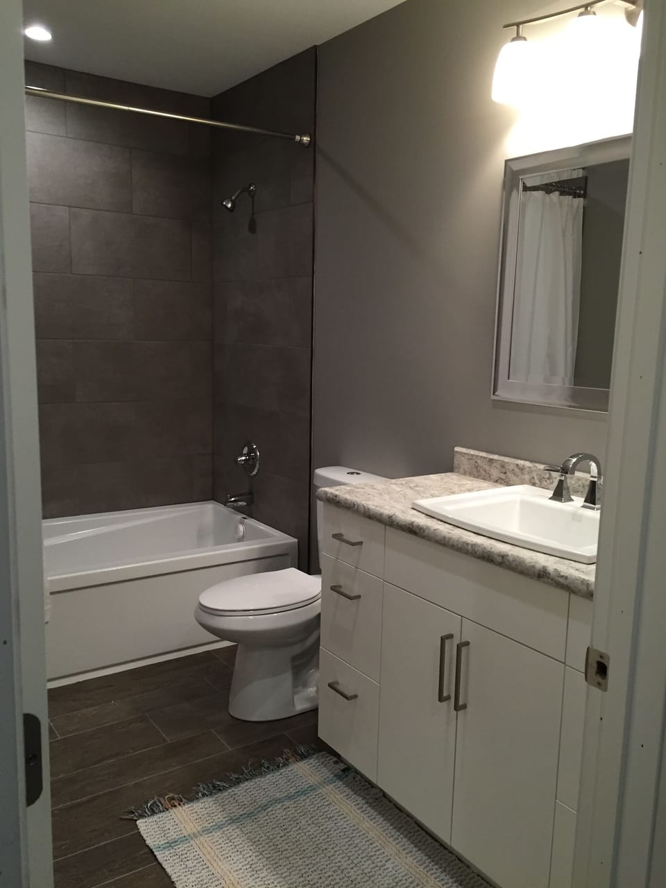 The bathroom on the main floor has a large bathtub, shower and toilet and sink. 