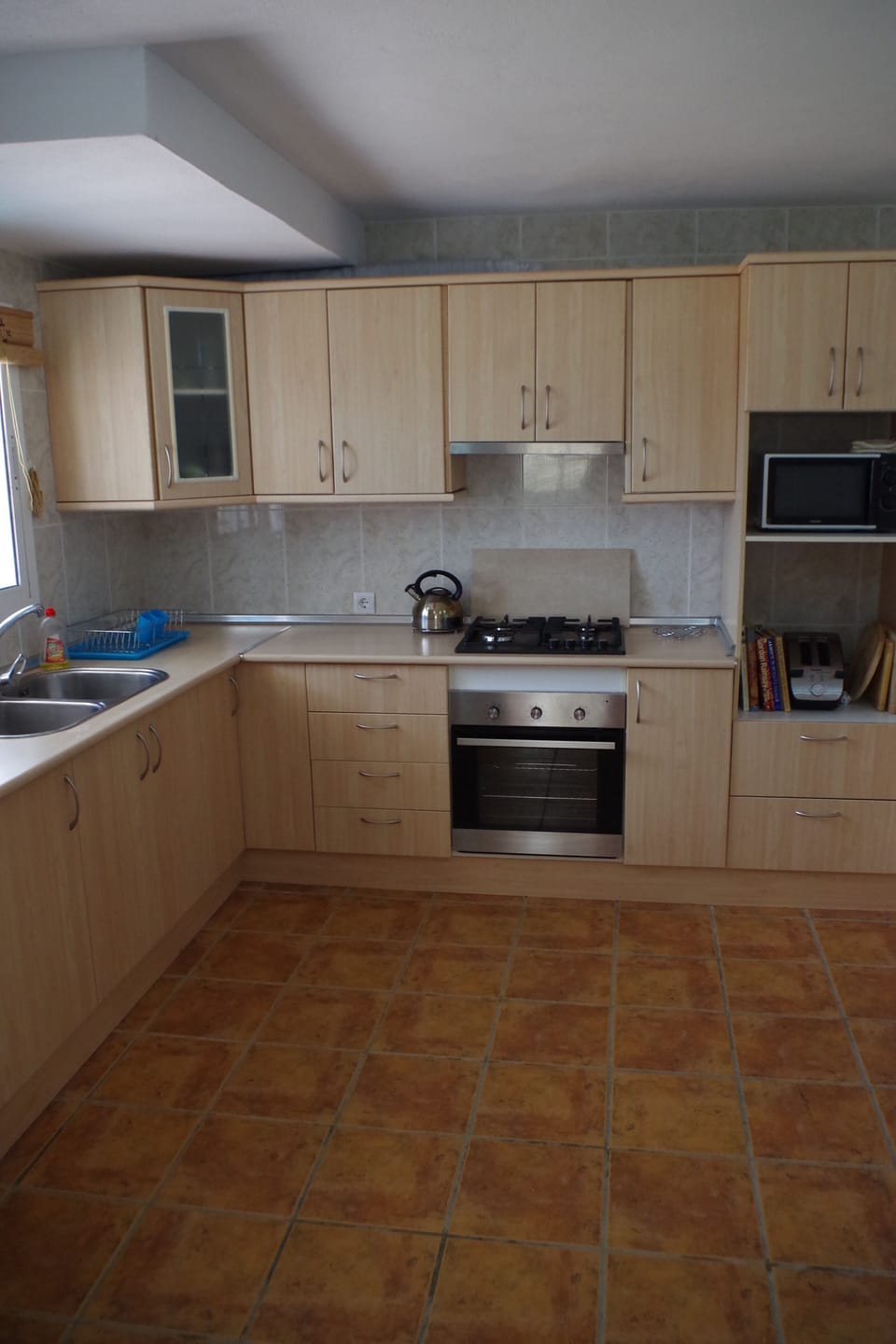 Fully equipped kitchen with microwave, toaster and coffee machine.