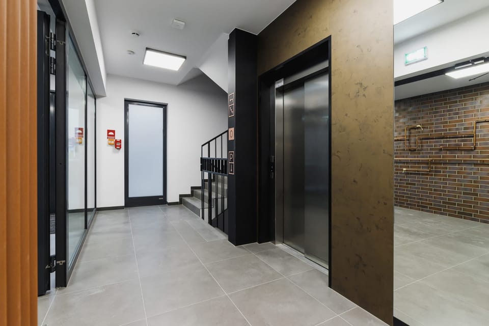 Another angle of the building's interior, highlighting brick and metal accents for a stylish aesthetic.