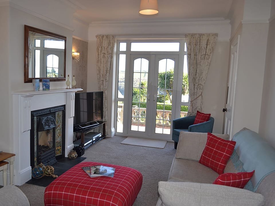 Stylish sitting room with French door leading out onto the patio | Riverview, Fowey