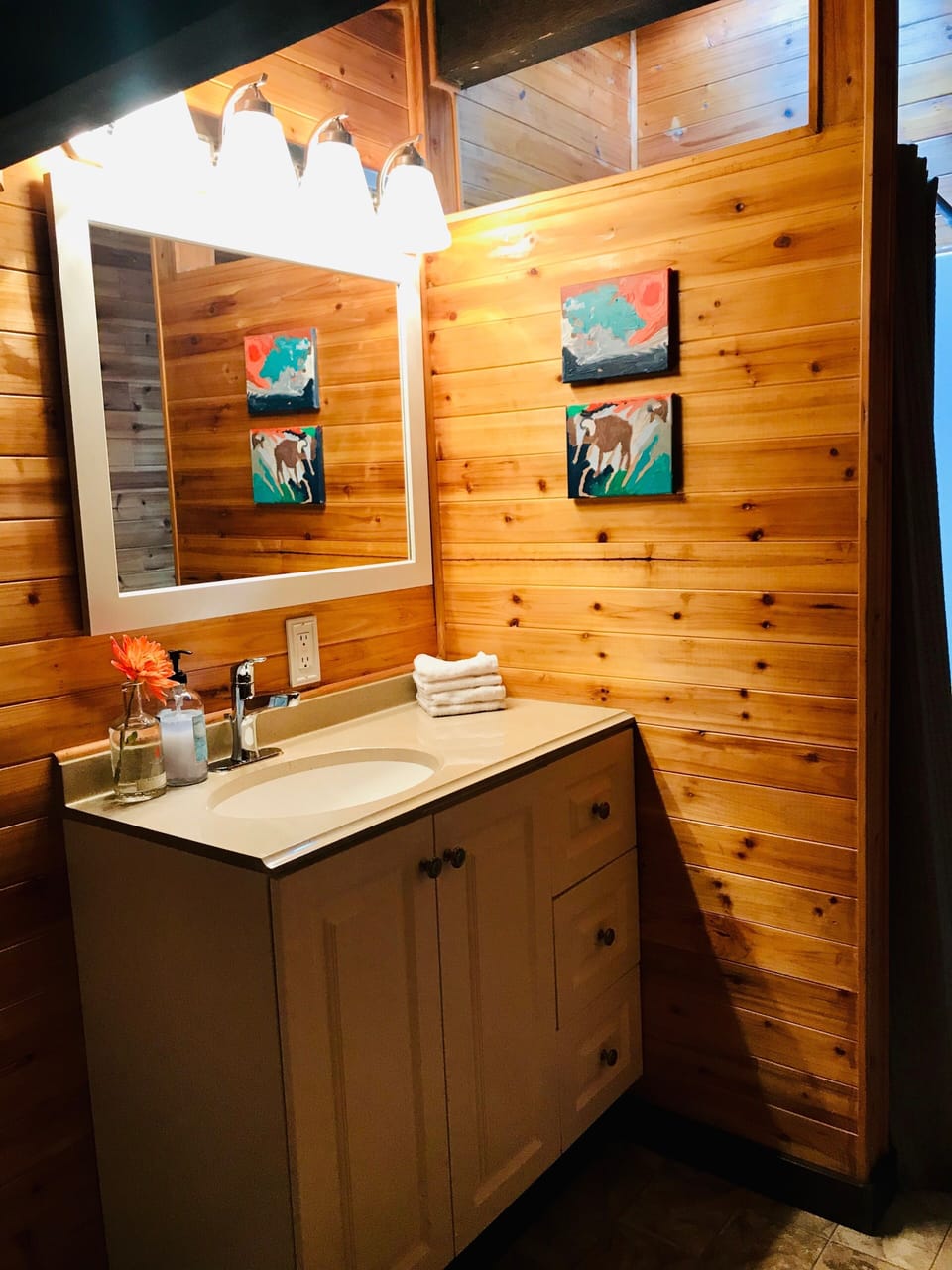 2nd floor bathroom, cedar walls + shower with a skylight