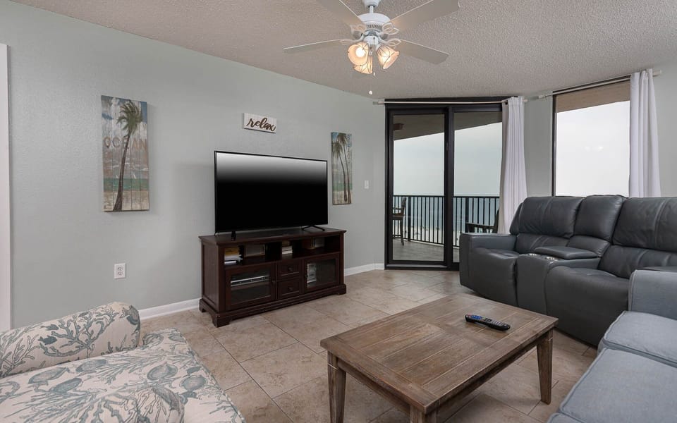 Relax in the inviting living area with comfortable seating and a large TV, perfect for unwinding after a day of fun