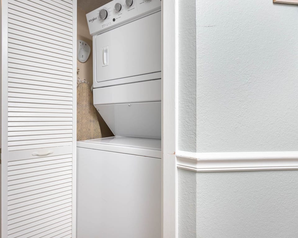 Conveniently wash and dry your clothes with this stacked washer and dryer, tucked neatly in the laundry closet