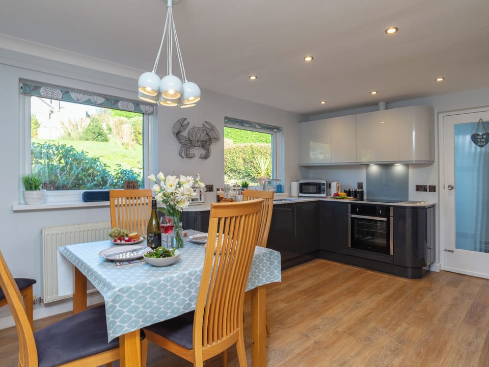 Fully equipped kitchen with dining area within the open-plan design | Bosula, Fowey