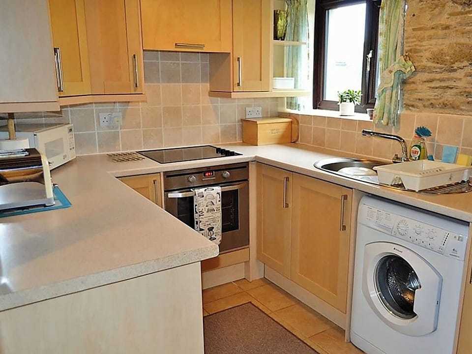 Well equipped galley style kitchen | Mill Cottage, Fowey