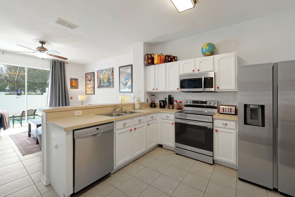 Kitchen looks over living area.