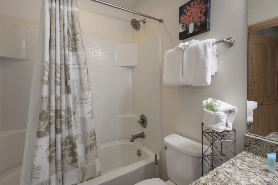 Your private bathroom features a relaxing tub-shower combo with plush towels and thoughtful touches for a refreshing start to your day.