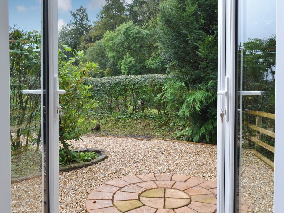 Patio doors leading to outdoor area | Blaithwaite Cottage - Blaithwaite Estate, Waverton, near Wigton