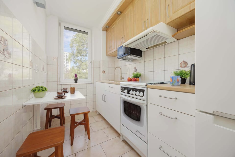 A cozy kitchen with a small dining table placed by the window, perfect for everyday meals.