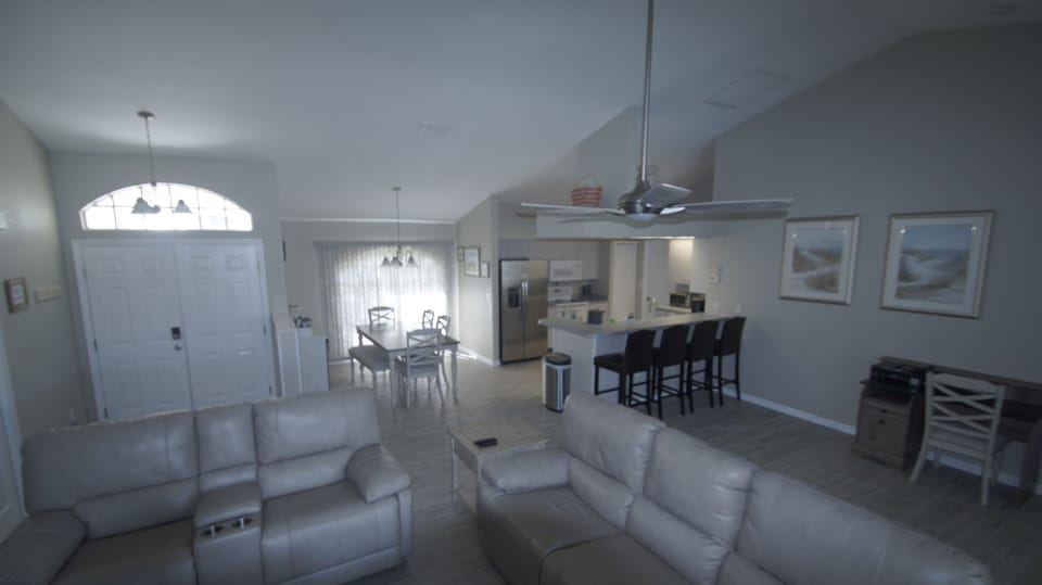 Open floor plan great room with breakfast bar seating for visiting diners
