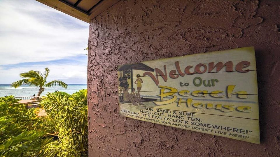 Charming “Welcome to Our Beach House” sign adds a warm, inviting touch