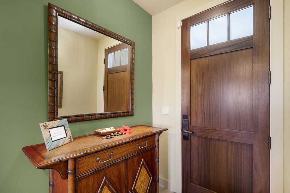 Foyer with mirror and small table.