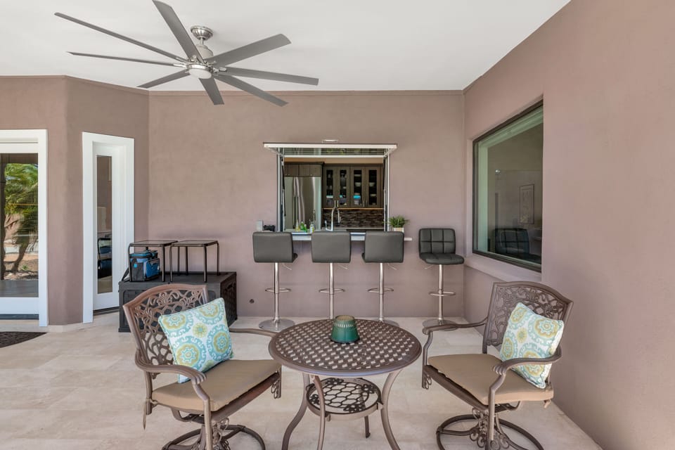 Covered Patio: Off kitchen w/pass-thru awning window, bar seating & 2-top set