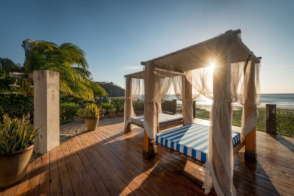 The front deck spans the white sands has beautiful beach beds to relax on