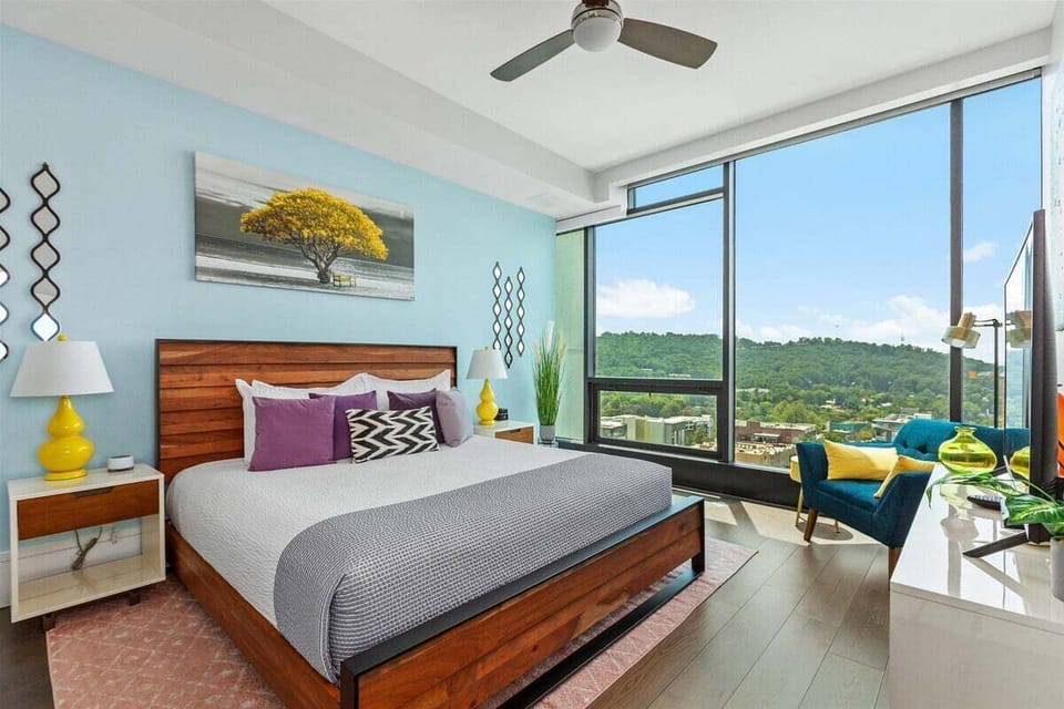 bedroom with king bed, side chair and 55 inch TV