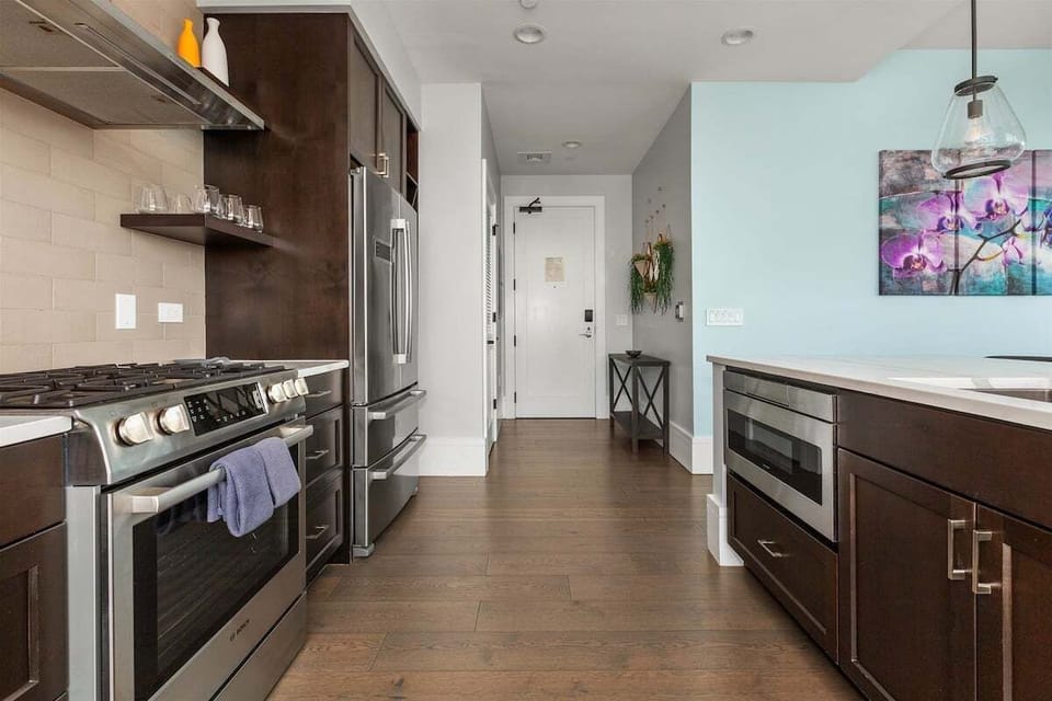 kitchen with 5 burner gas stove, dishwasher, microwave and refrigerator