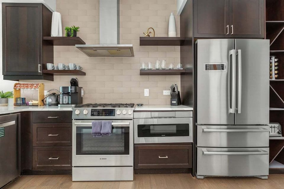 Kitchen with 5 burner gas stove, microwave, dishwasher and plenty of storage