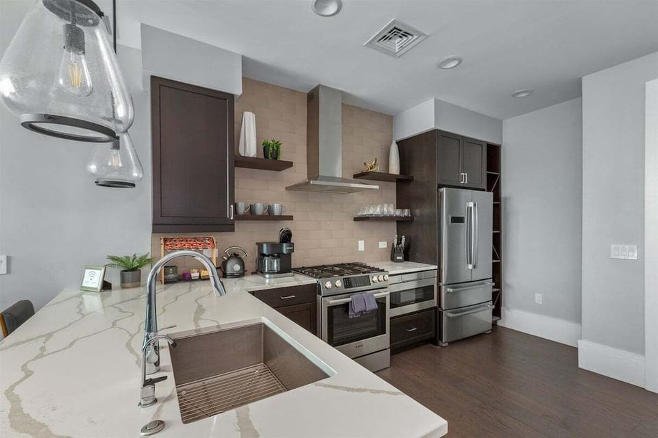 Kitchen with 5 burner gas stove, microwave, dishwasher and plenty of storage