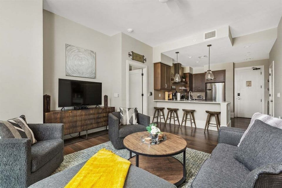 Living room overlooking into the kitchen with a breakfast bar seating 4