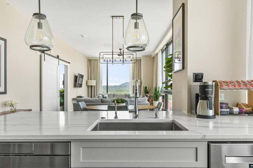 View from kitchen sink and open concept to dining and living room