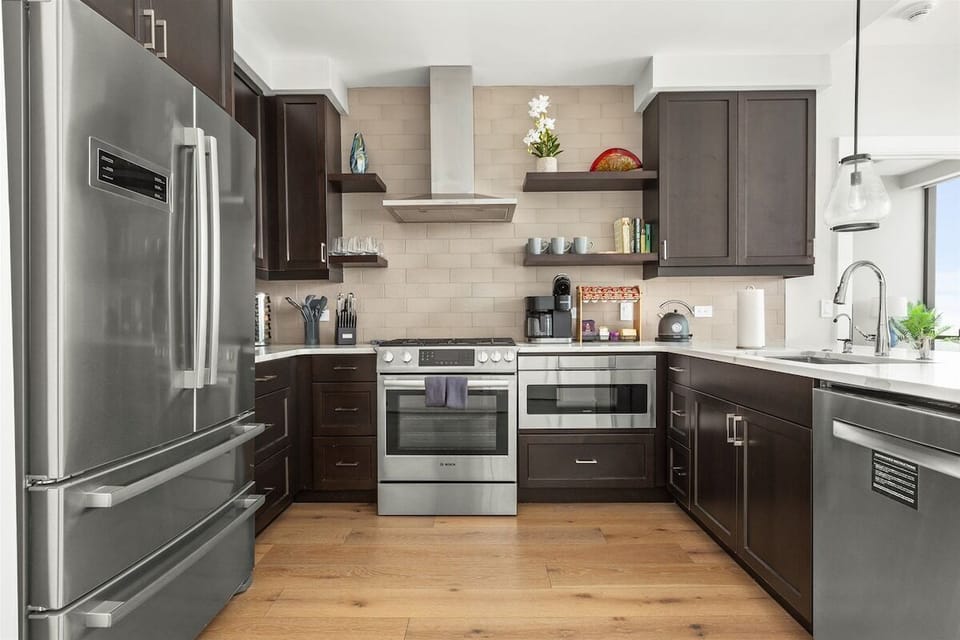 Kitchen with 5 burner gas stove, microwave, dishwasher and plenty of storage