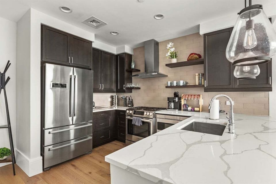 Kitchen with 5 burner gas stove, microwave, dishwasher and plenty of storage