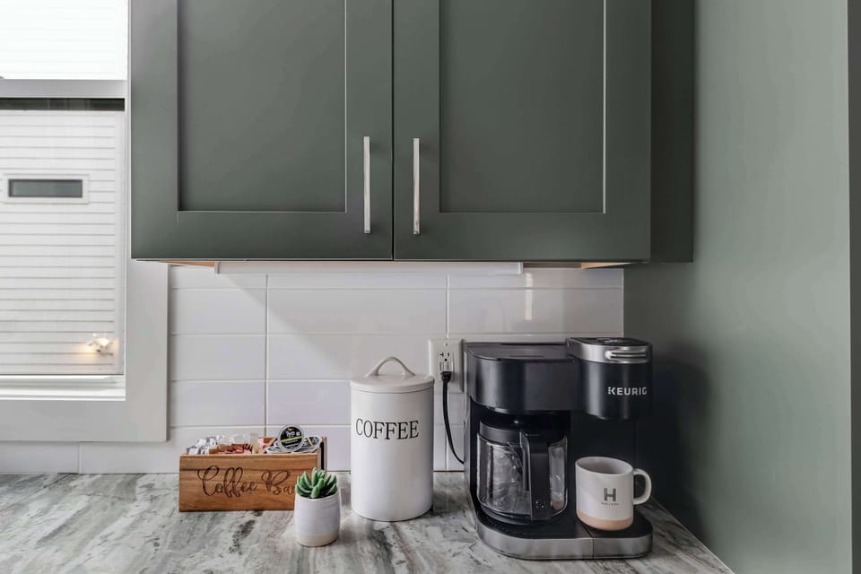 Coffee bar with drip coffeemaker, Keurig, and essentials.
