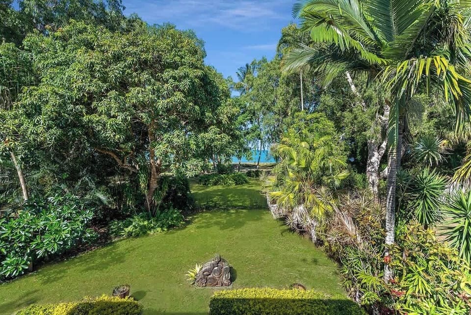 This private oasis backs up to a lush backyard and enjoys direct access to the beach.