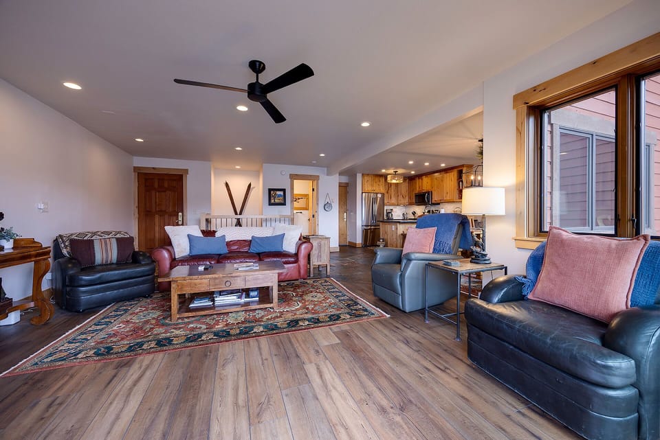 Settle into your spacious living area with plush leather seating and mountain views through panoramic windows.