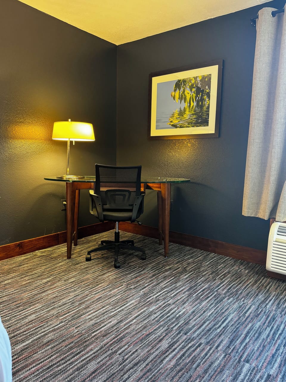 Premium bedding, desk, laptop workspace, blackout drapes