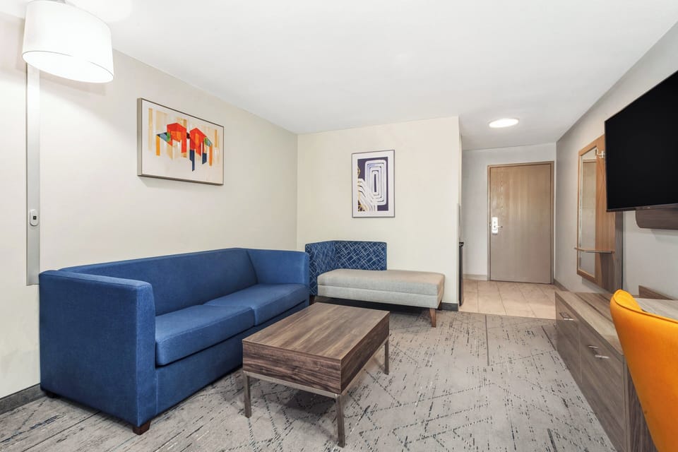 Premium bedding, desk, laptop workspace, blackout drapes