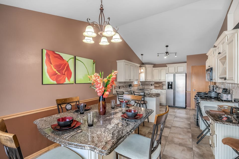 Dining table is bar height and can sit 6. Dinnerware for 10 is provided
