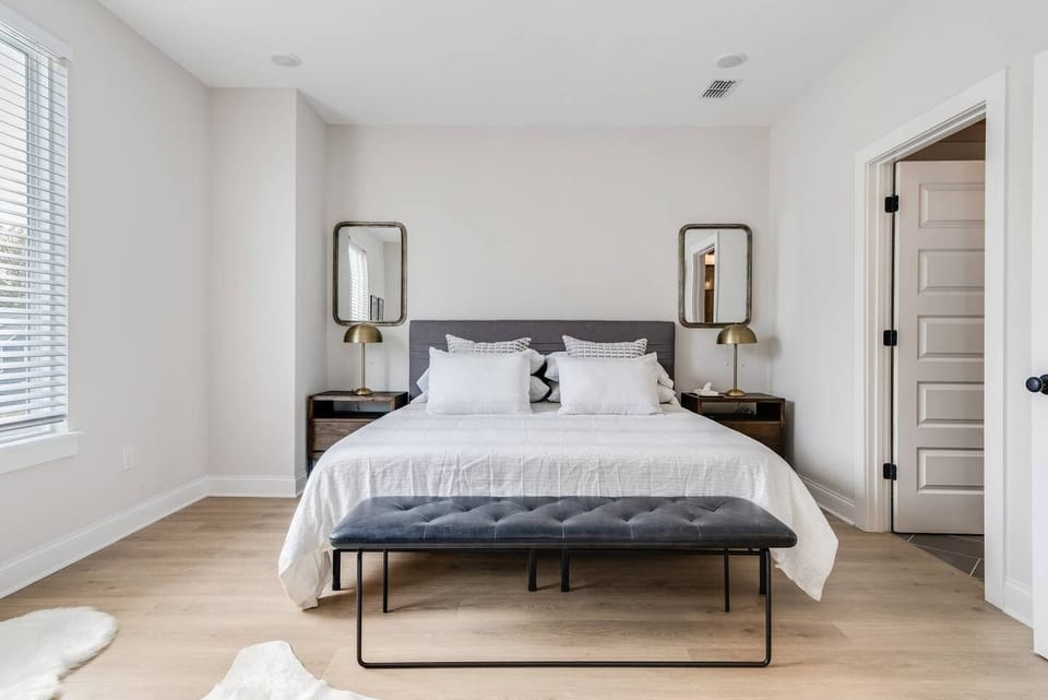 A private en-suite bath for every bedroom — nobody waits in the hall. Third floor king suite with a walk-in shower and double vanity.
