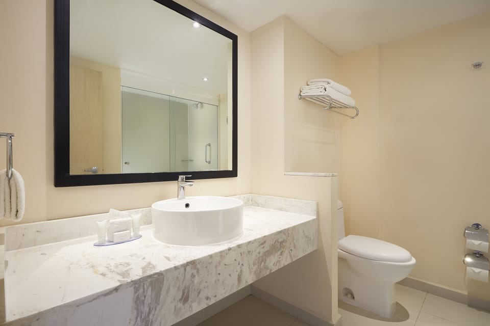 Shower, designer toiletries, hair dryer, towels