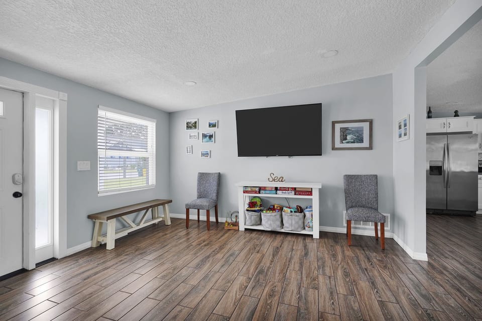 Additional living room seating and a 65" smart TV