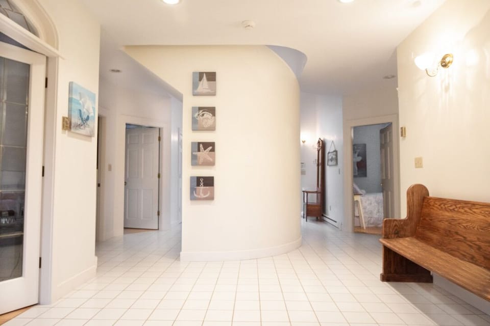 Downstairs entry foyer, off of which are 3 bedrooms, a library & a laundry room.
