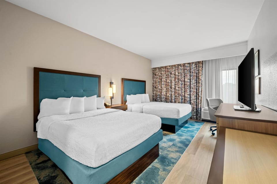 Room, 2 Queen Beds, Non Smoking | Desk, blackout drapes, iron/ironing board, free cribs/infant beds