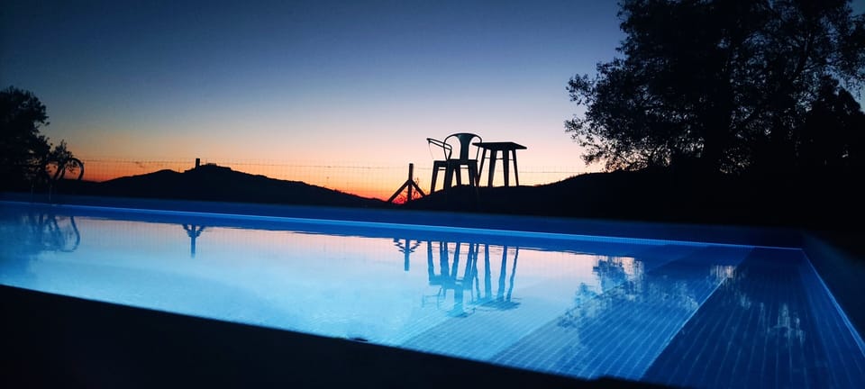 The pool is illuminated at night.