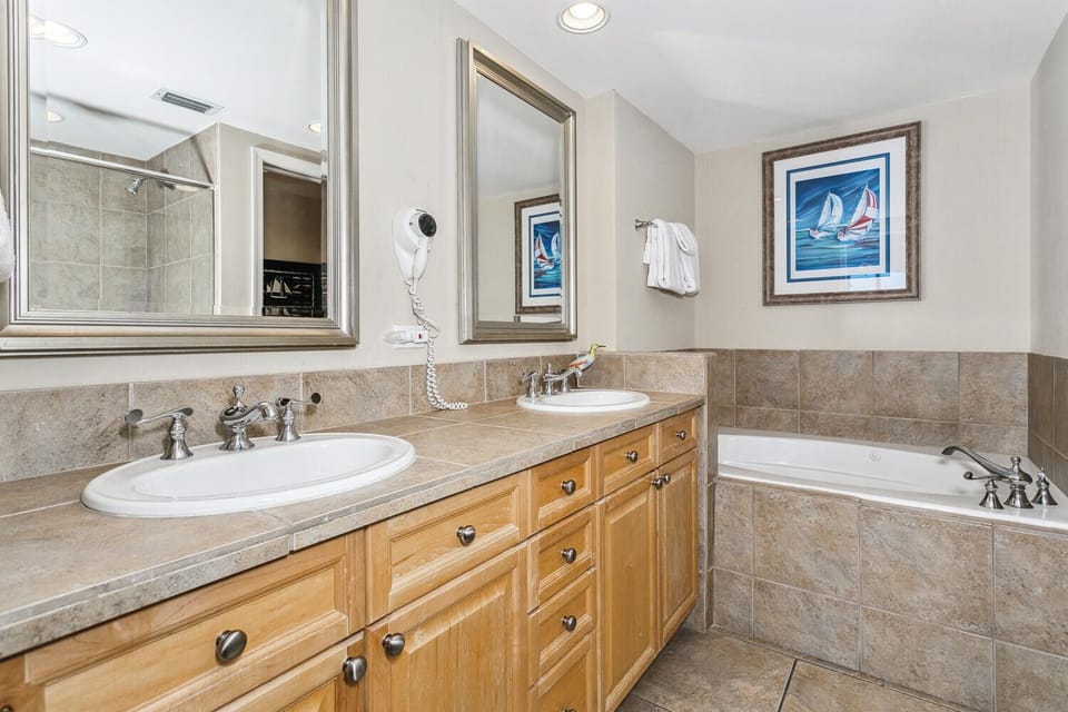 Refresh in your spacious bathroom with a soaking tub, dual sinks with gleaming fixtures, and a separate walk-in shower—everything you need to unwind after a day of exploring.