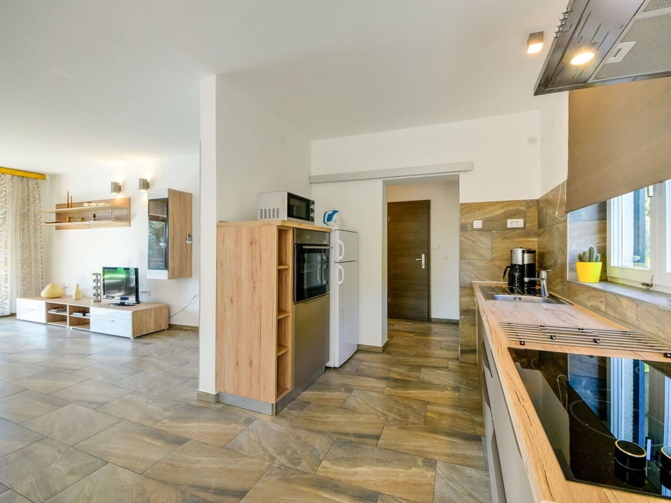 Property, Cabinetry, Wood, Hall, Window, Kitchen, Countertop, Interior Design, Floor, Flooring